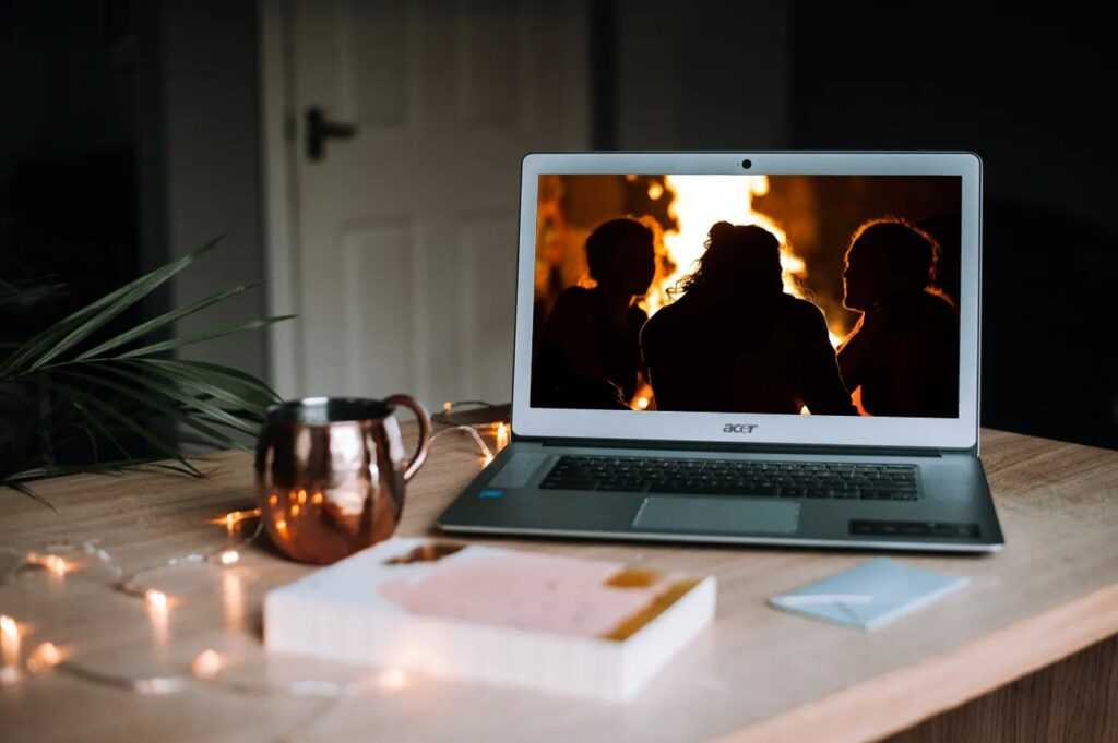 group around fire on laptop